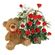 Teddy Bear & Roses. A charming teddy bear and and arrangement of tender red roses with greens in basket.. Nizhny Novgorod